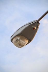Close-up of a high-quality LED streetlight mounted on a sturdy pole against a clear sky.