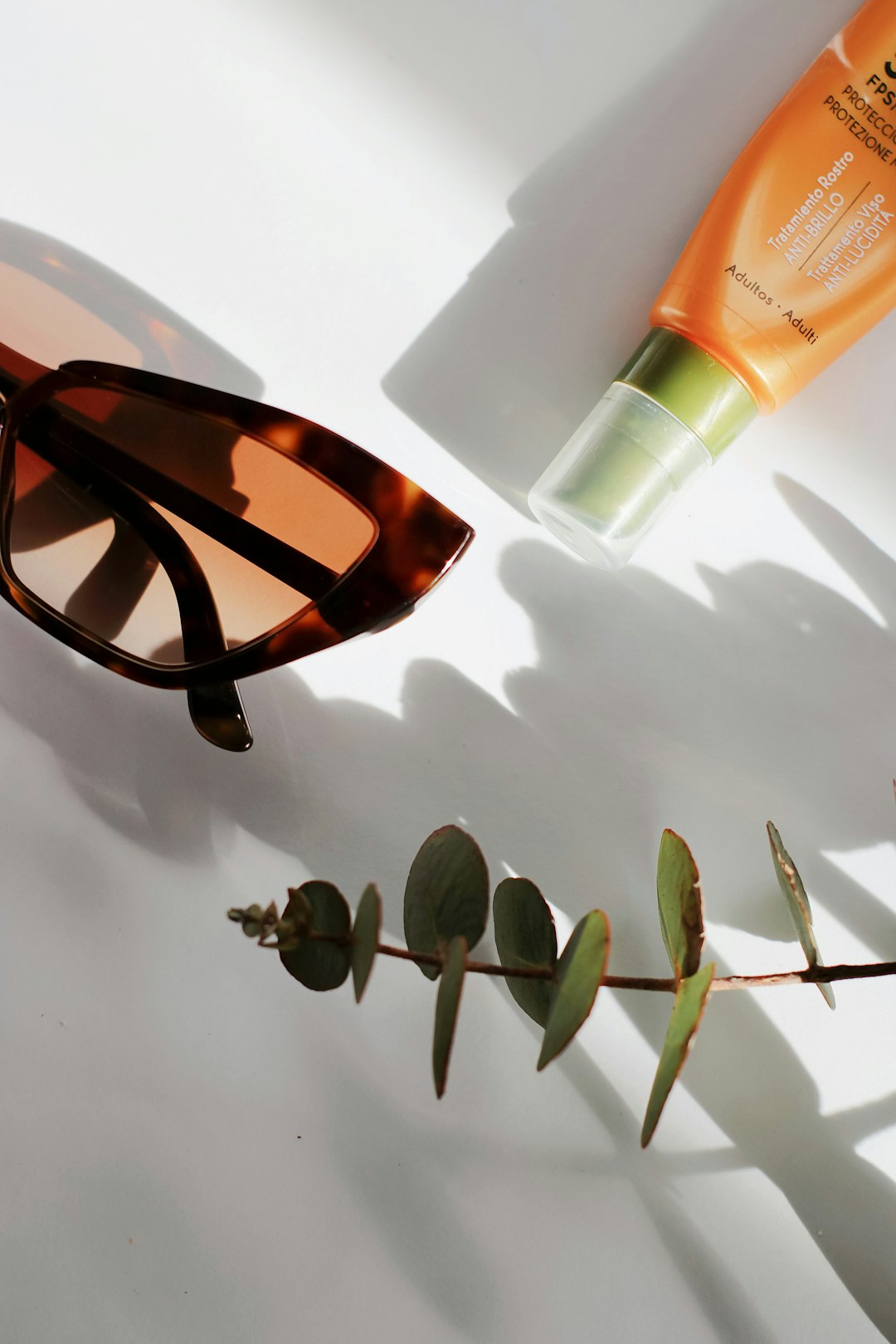 black framed sunglasses on white table