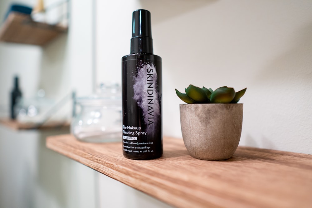 black and purple bottle on brown wooden table