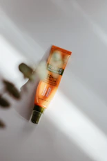 orange and black tube bottle