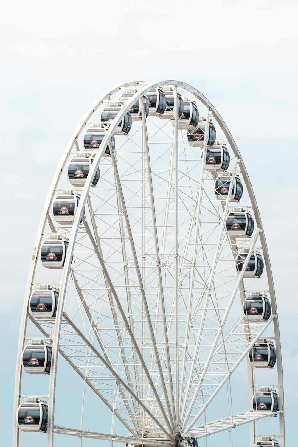 white ferris wheel under white sky during daytime