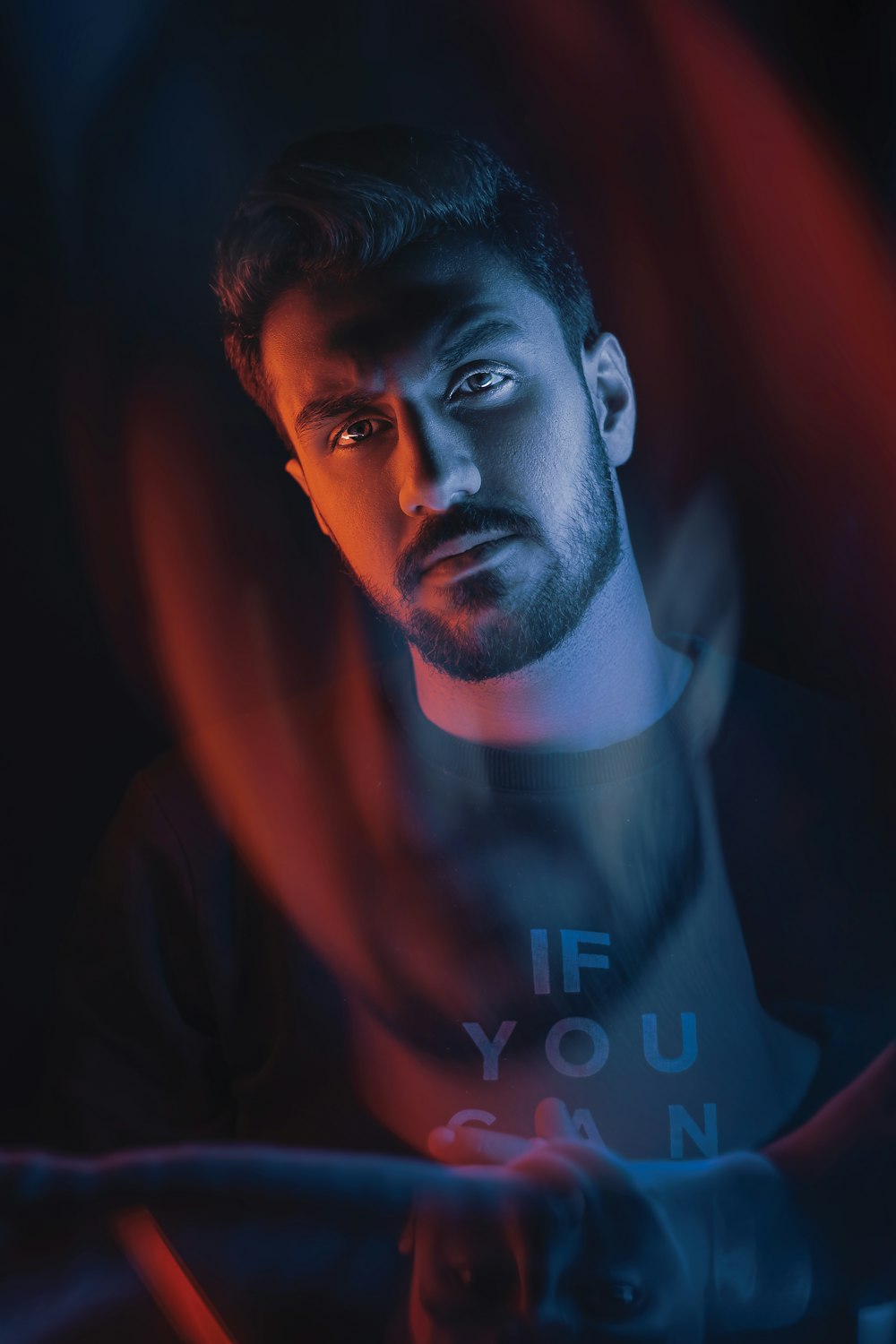 man in black shirt with red background