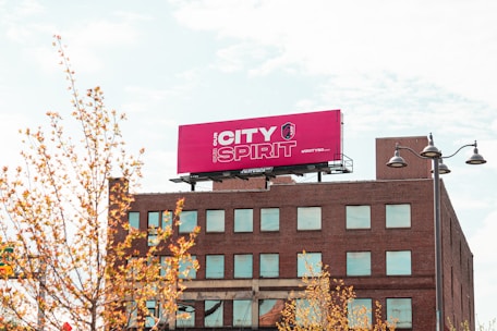 brown concrete building with red and white signage