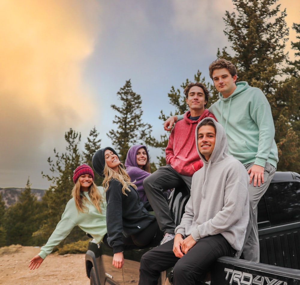 group of people sitting on black metal bench