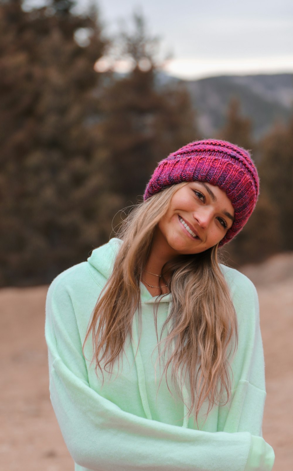 woman in pink knit cap and pink hoodie