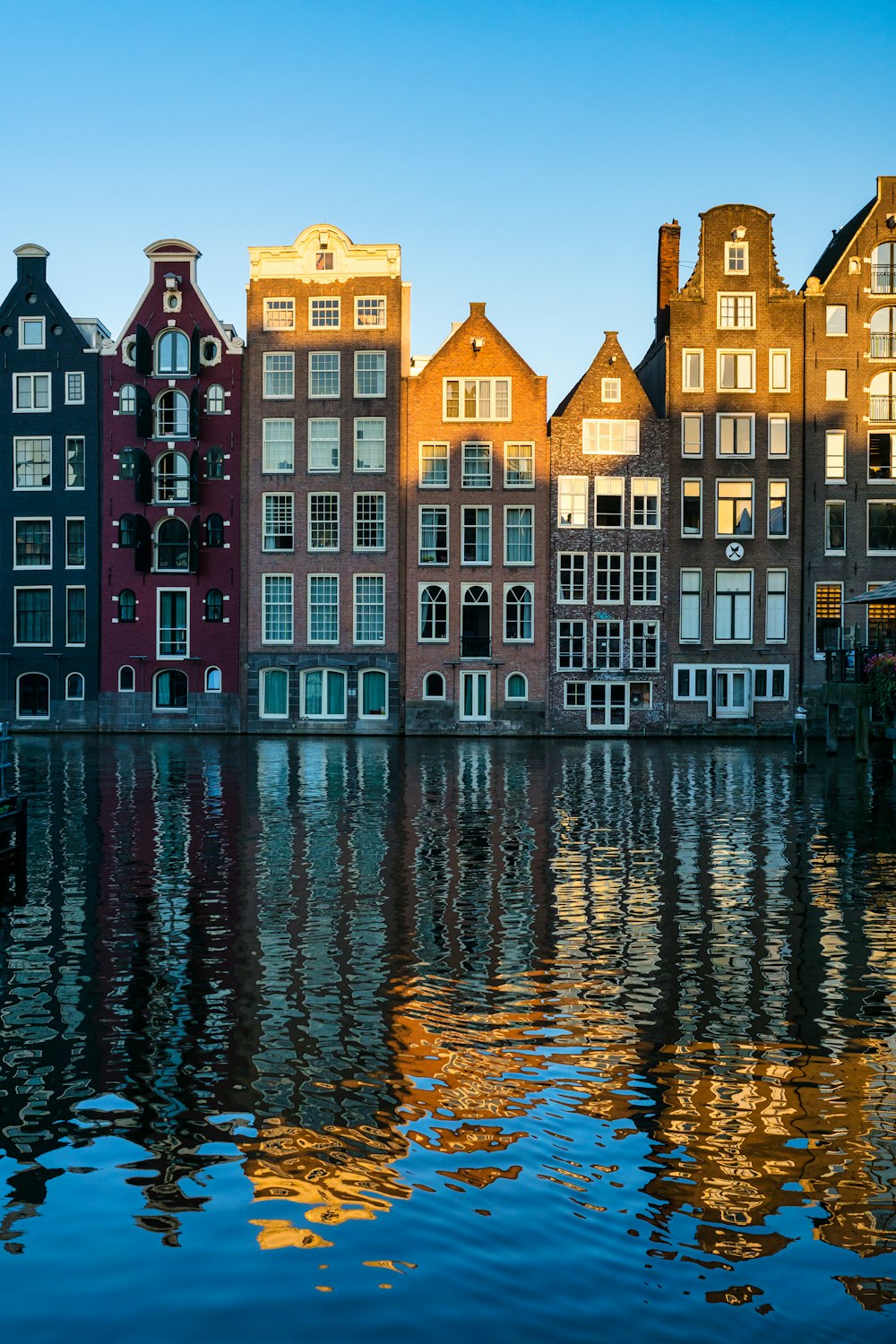 brown and black concrete building beside body of water during daytime