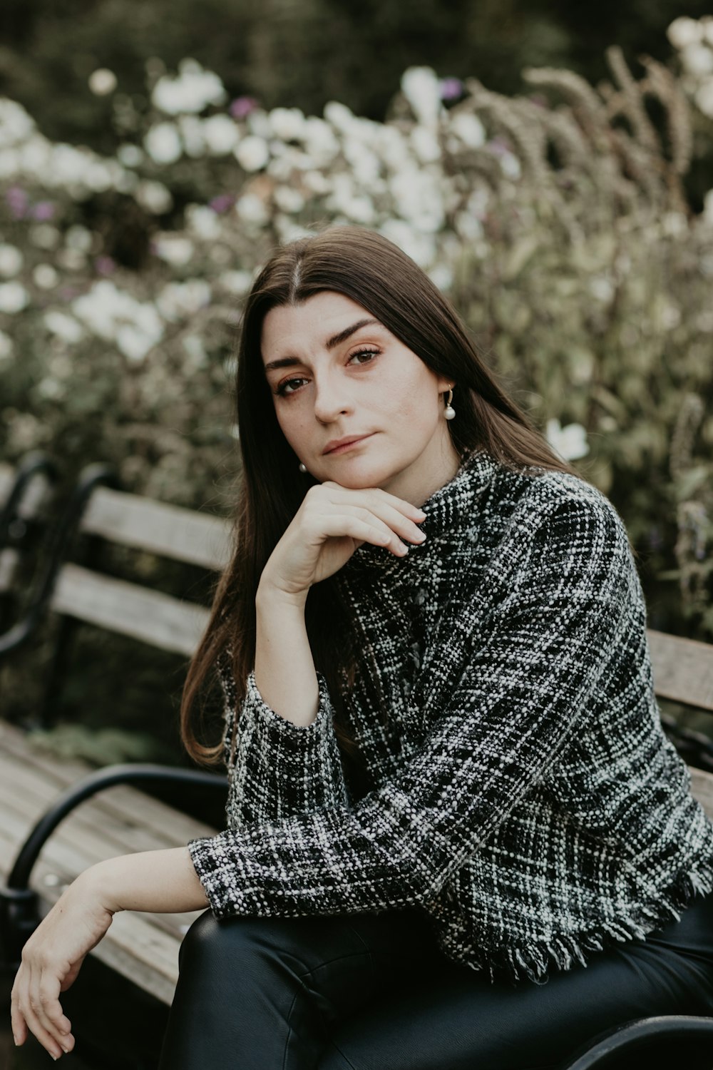 woman in black and white long sleeve shirt sitting on black metal chair