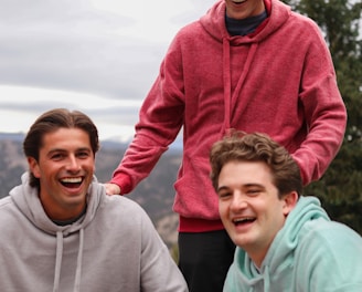 man in red hoodie beside woman in gray hoodie