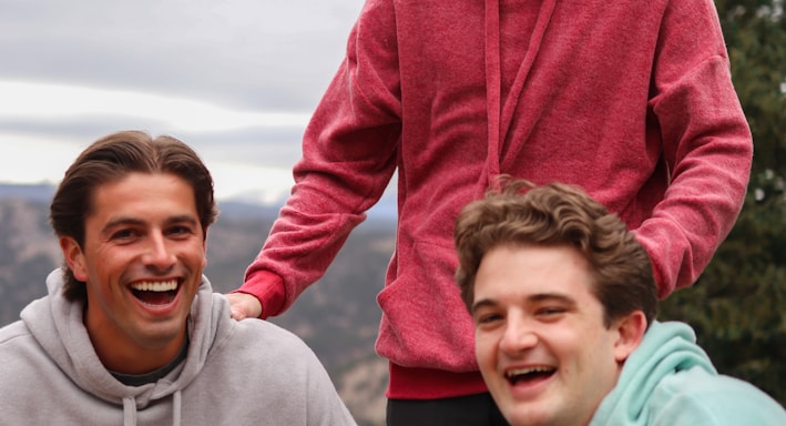 man in red hoodie beside woman in gray hoodie