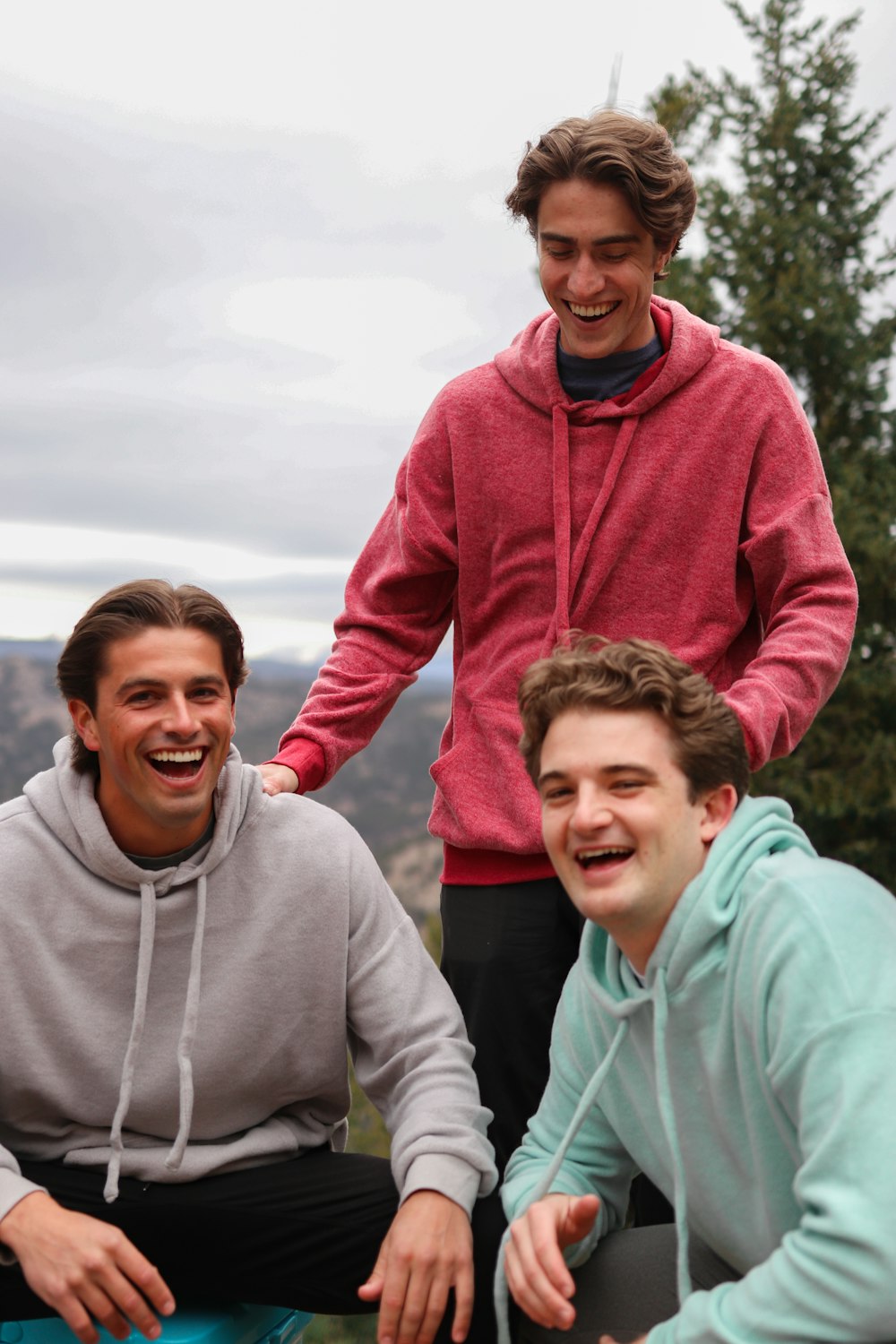 man in red hoodie beside woman in gray hoodie