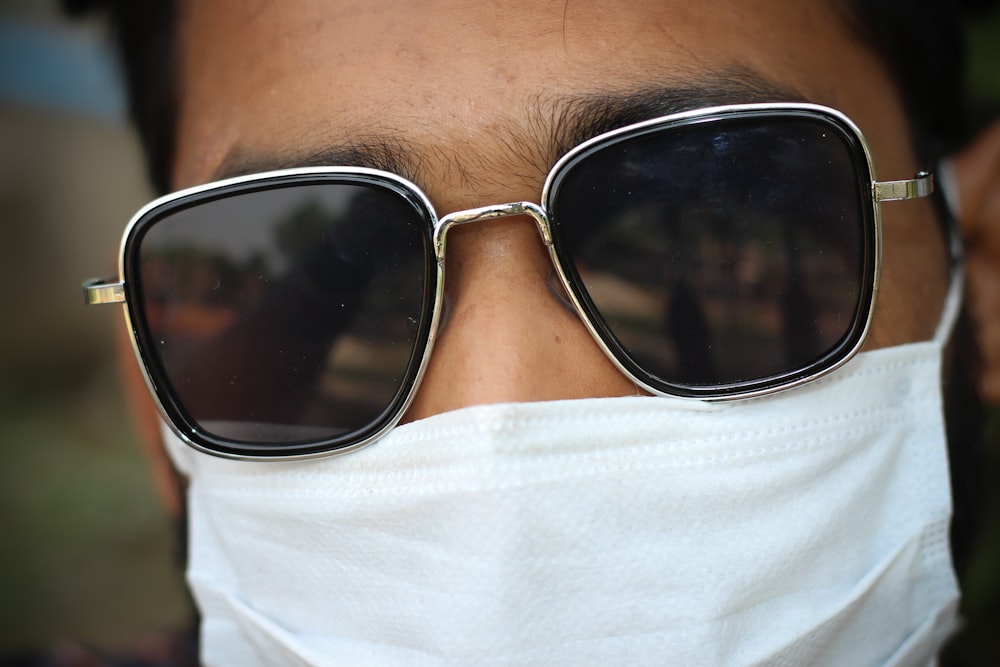 man in white shirt wearing black sunglasses