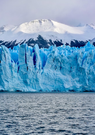 white and blue ice on body of water during daytime