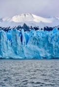 white and blue ice on body of water during daytime