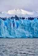 white and blue ice on body of water during daytime
