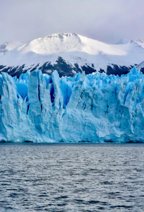 white and blue ice on body of water during daytime