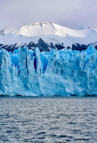 white and blue ice on body of water during daytime