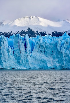 white and blue ice on body of water during daytime