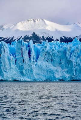 white and blue ice on body of water during daytime