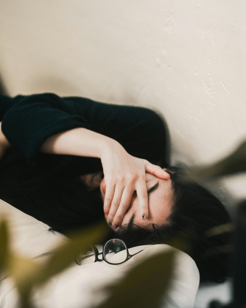 woman in black long sleeve shirt covering her face