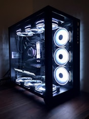 black and white speakers on brown wooden floor