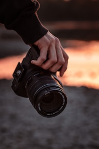 person holding black dslr camera
