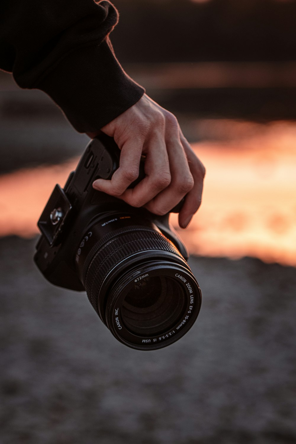 person holding black dslr camera