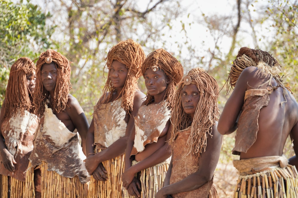 women in white dress standing on brown soil during daytime