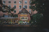 A cozy café terrace overlooking a bustling street.