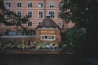 A cozy cafe terrace filled with people enjoying their drinks.