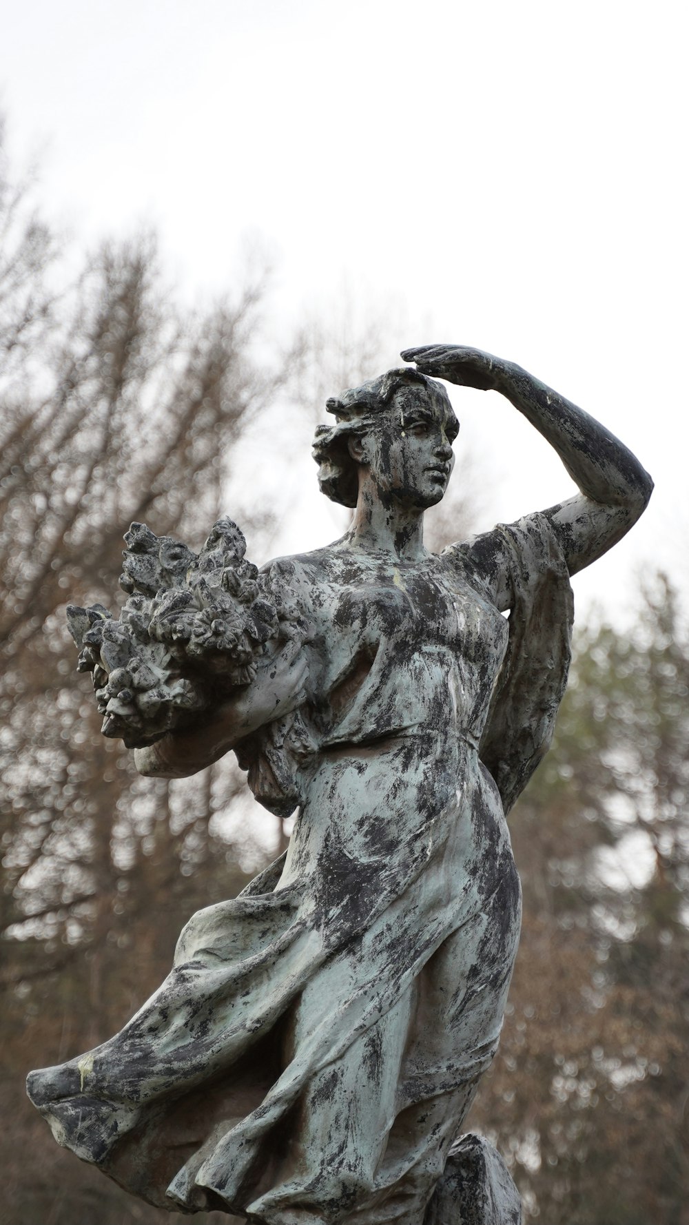 man holding a bird statue