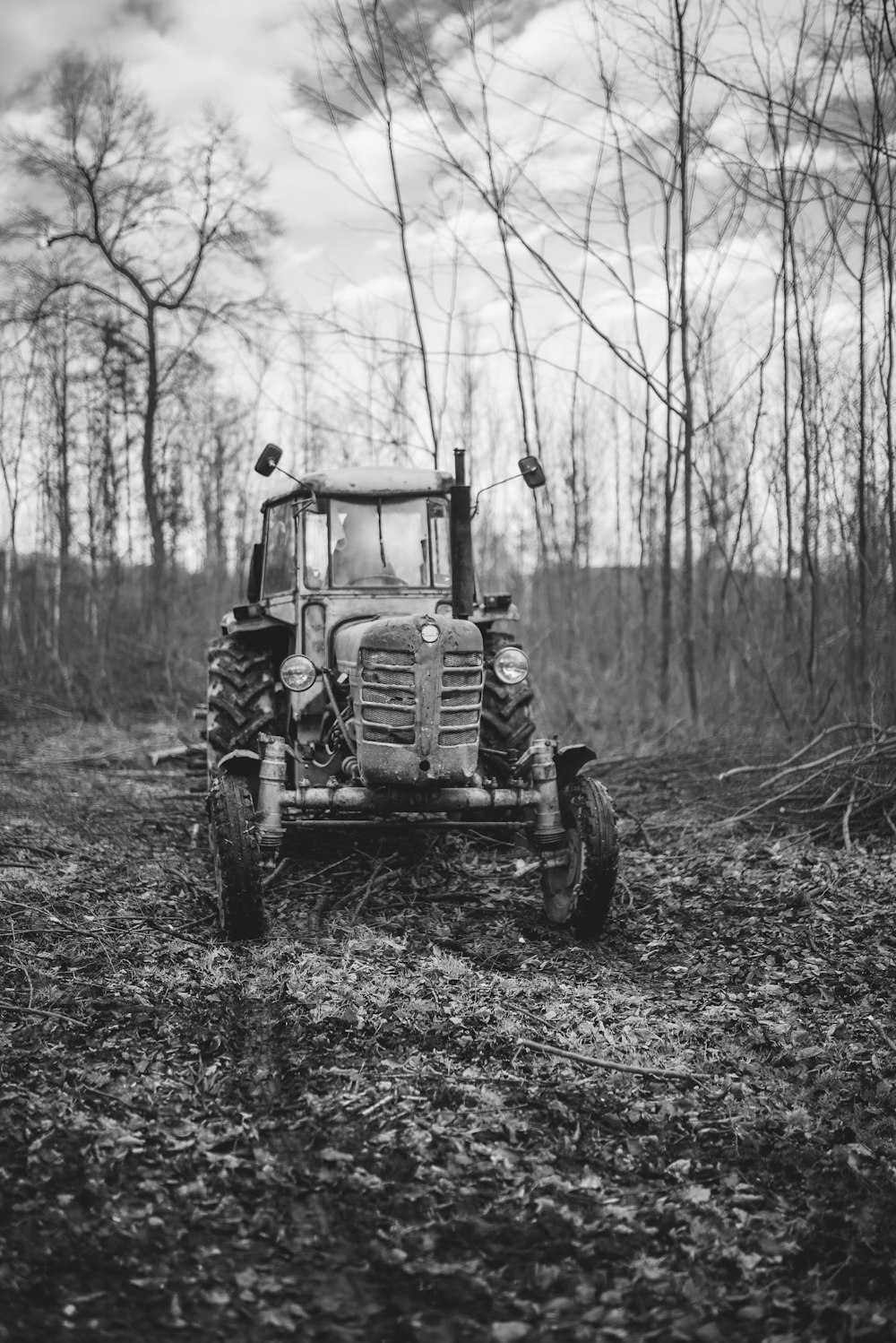 grayscale photo of tractor in forest