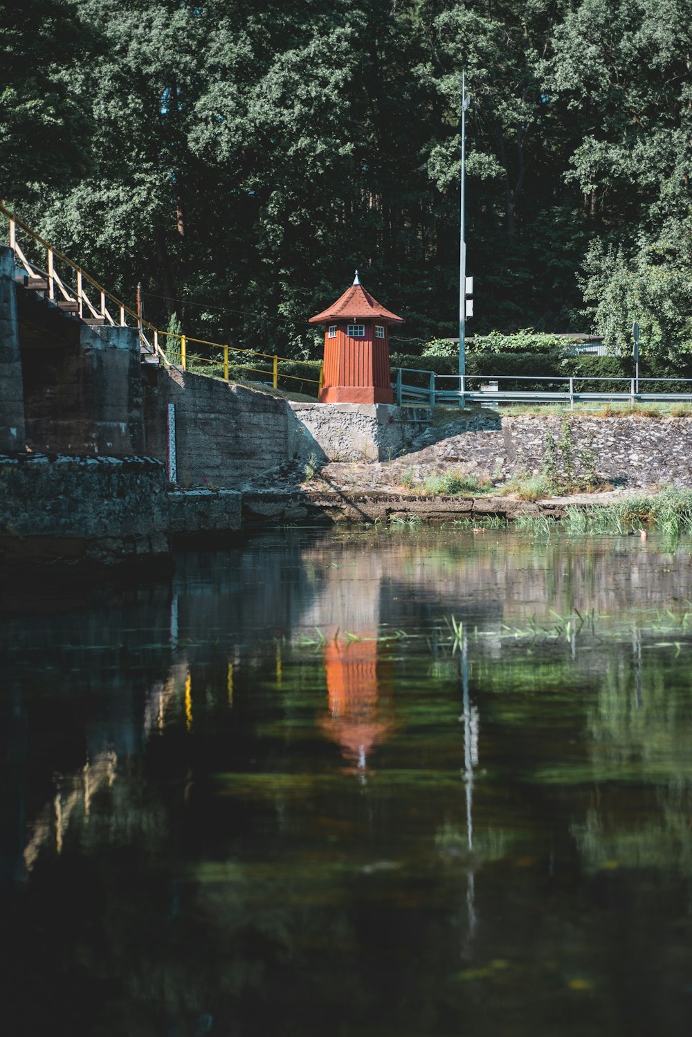 red and white house near body of water during daytime