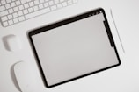 A minimalist desk setup featuring a digital planner on a tablet.