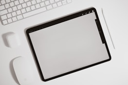 A minimalist desk setup featuring a tablet showing a digital takeoff tool.