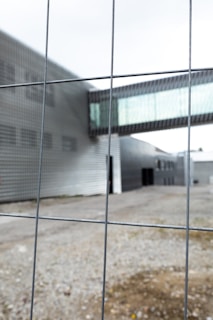 A sleek aluminum fence with a modern gate, framing a commercial property entrance.