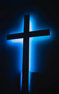 brown wooden cross on orange background