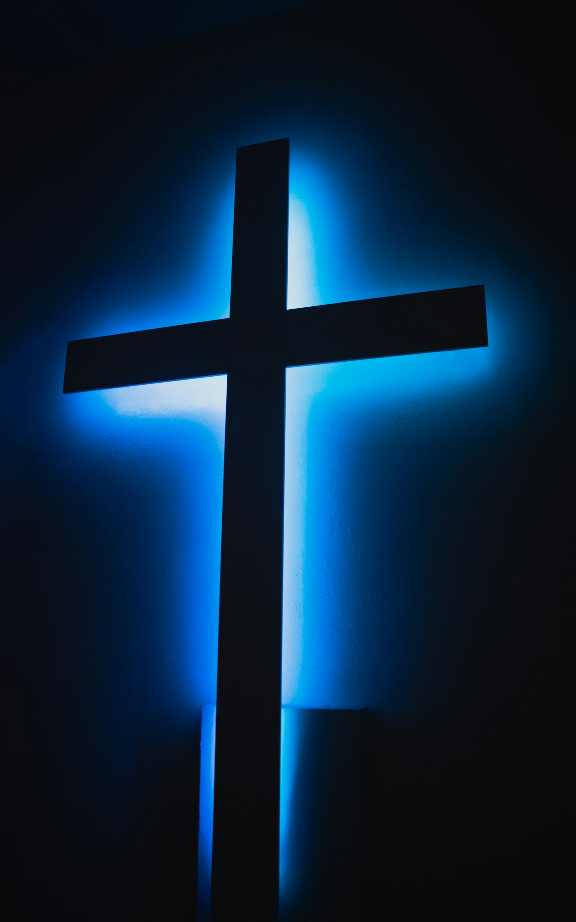 brown wooden cross on orange background
