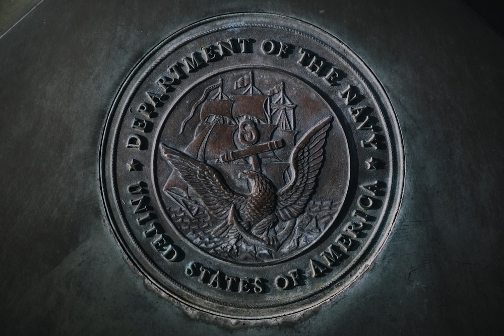 silver round coin on gray textile