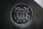 round silver coin on black textile