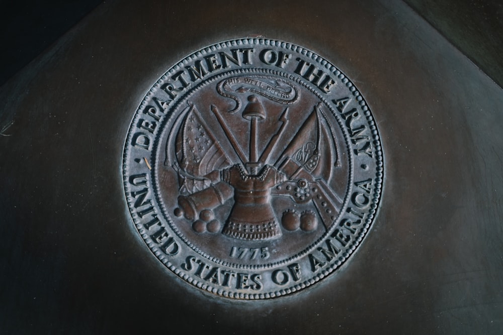 silver round coin on black textile