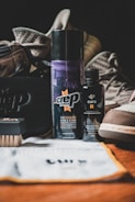 Close-up of premium shoe care products neatly arranged on a white surface with golden accents