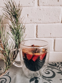 Close-up of a steaming cup of quentão, a traditional hot spiced drink.