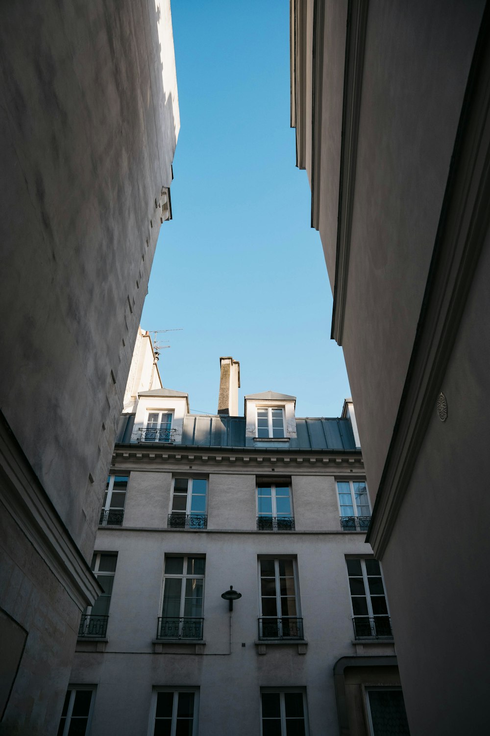 low angle photography of white concrete building during daytime