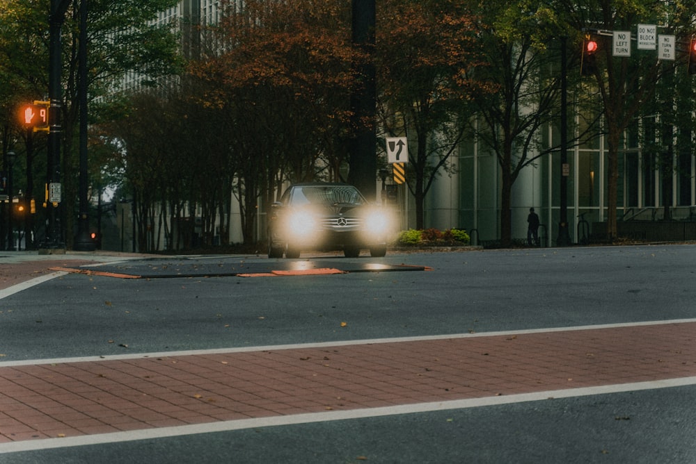 gray concrete road between green trees during daytime