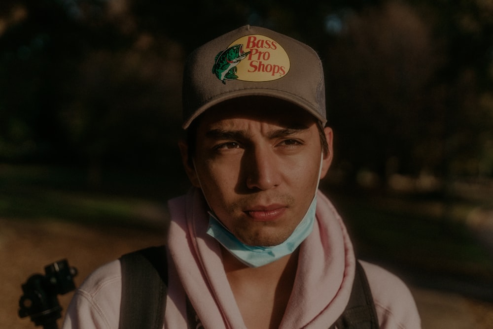 man in black fitted cap and white scarf