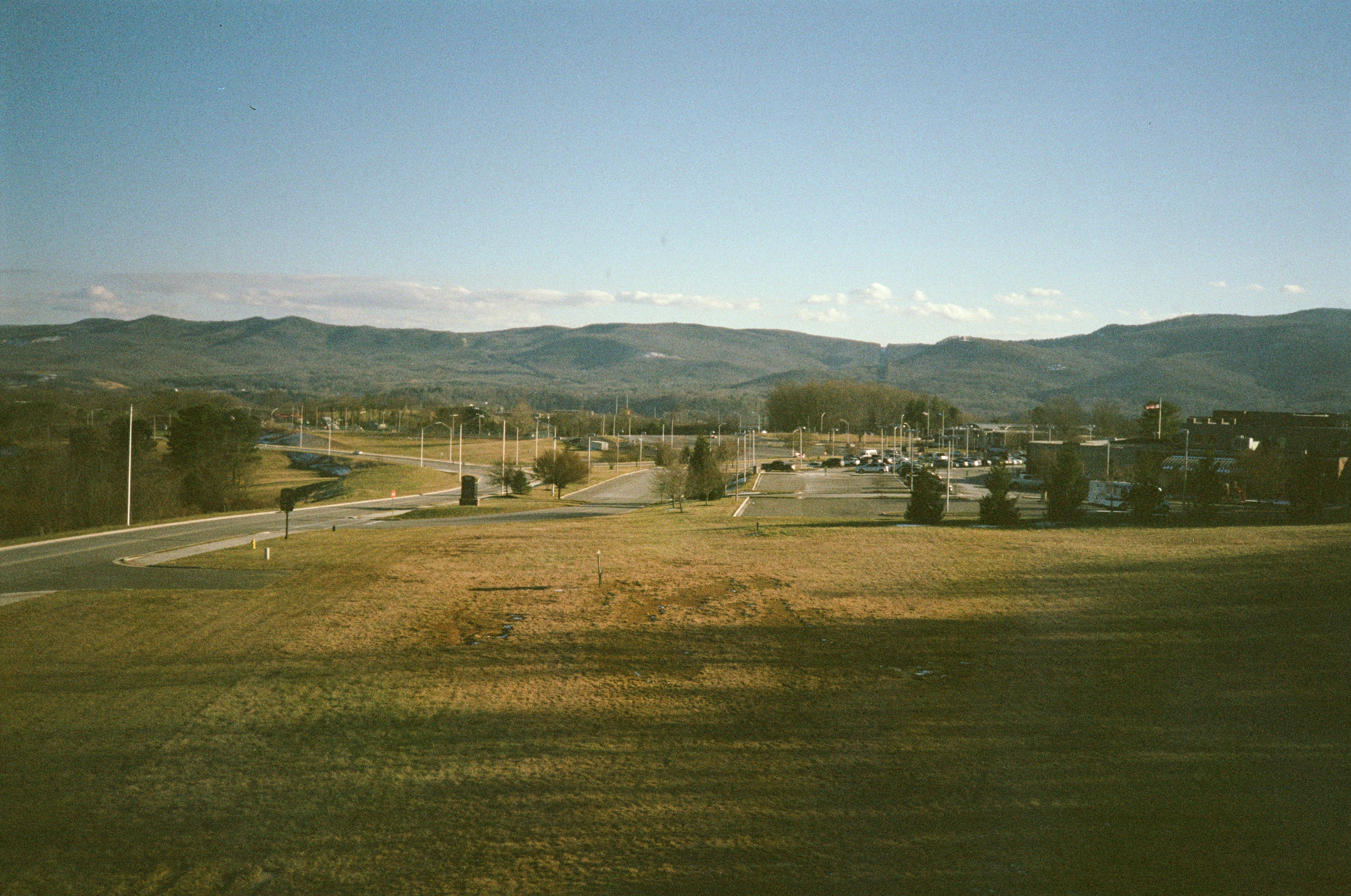 white and black house near green grass field during daytime