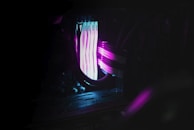 Close-up shot of state-of-the-art computer processors and components displayed on reflective glass with soft-focus purple lighting.