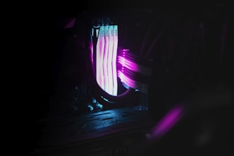 A sleek, futuristic quantum computer glowing with blue light inside a cloud-shaped frame.