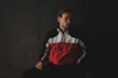 man in black white and red long sleeve shirt sitting on black chair