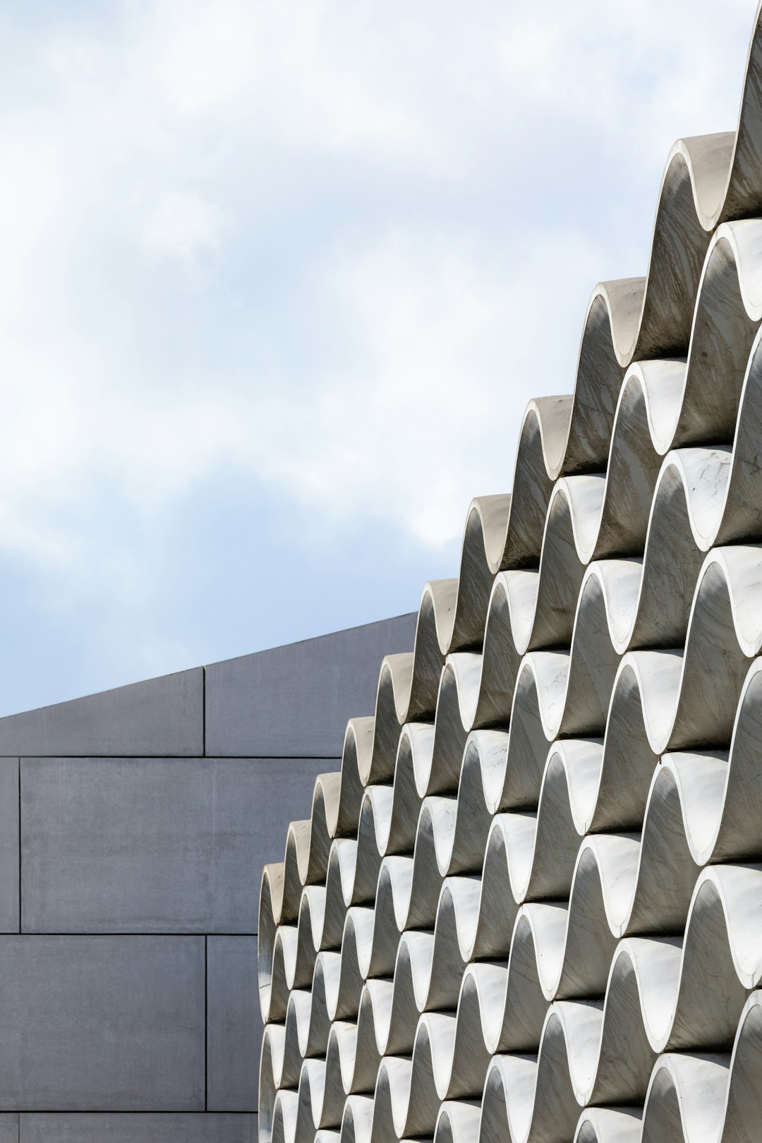 gray concrete building under white clouds during daytime